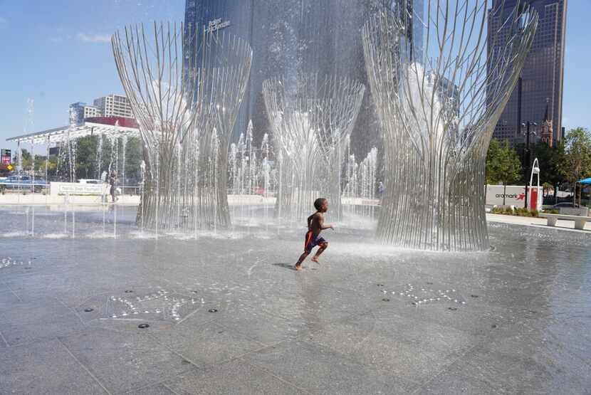 A child plays in the Nancy Best Fountain at Klyde Warren Park on Sept. 14, 2022.