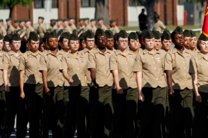 In this Friday, April 29, 2016 photo, new Marines march in formation in a graduation...