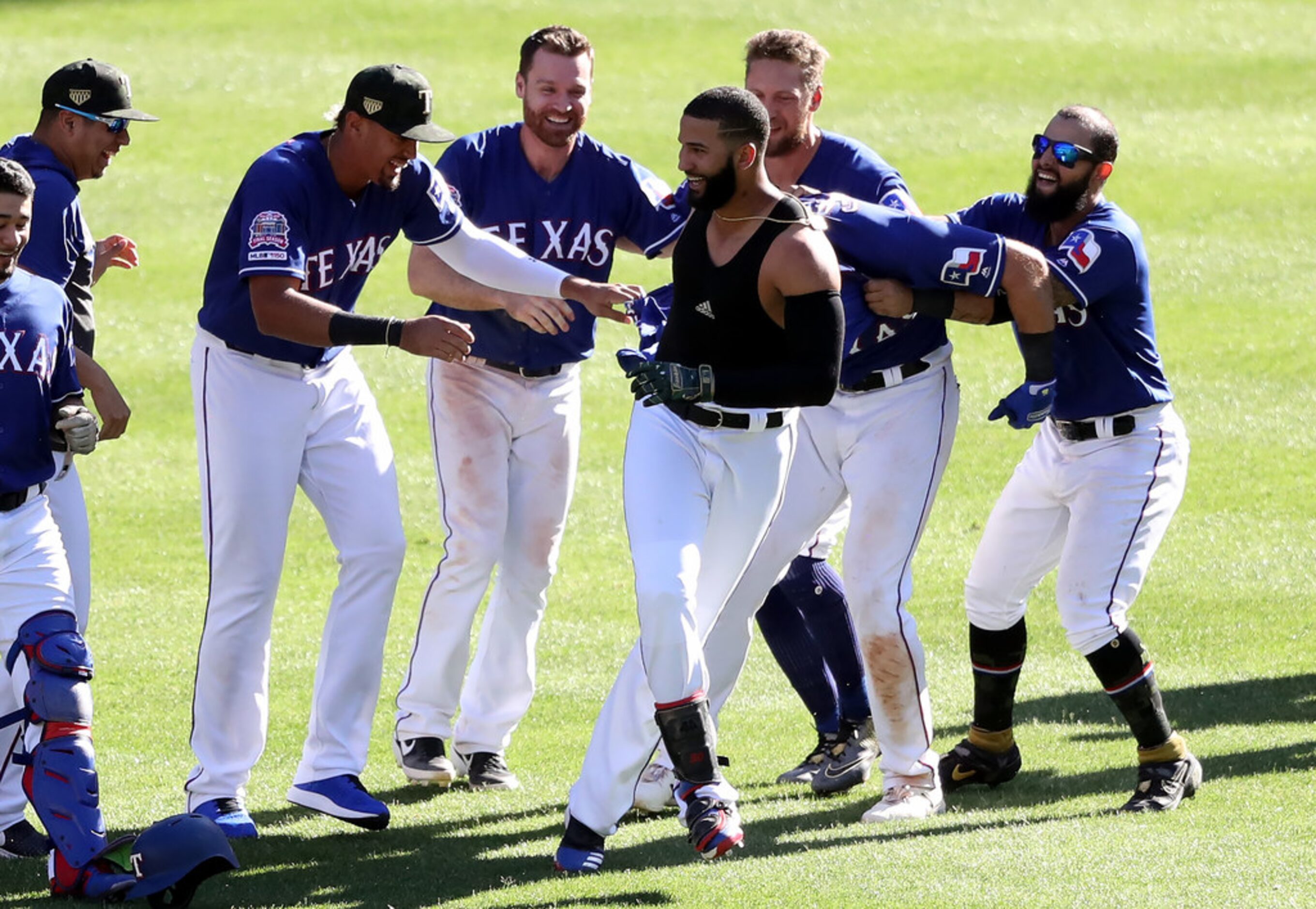 ARLINGTON, TEXAS - MAY 19:  The Texas Rangers celebrate the game winning run scored on a...