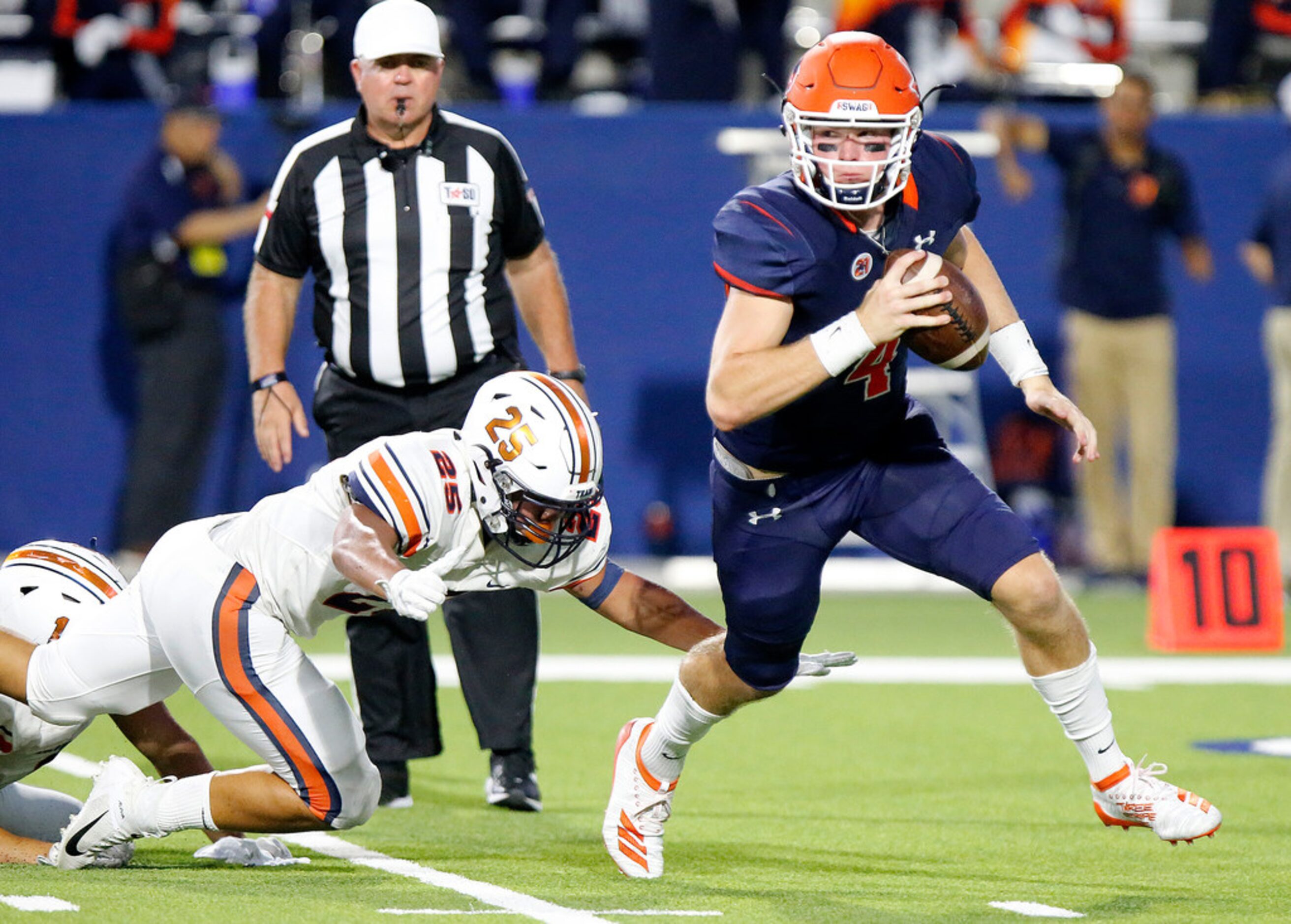 McKinney North High School quarterback Dillon Markiewicz (4) attempts to scramble from...