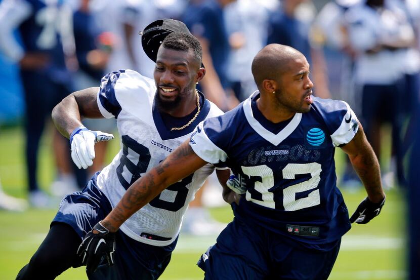 Dallas Cowboys wide receiver Dez Bryant (88) looses his hat as he is tightly covered by...