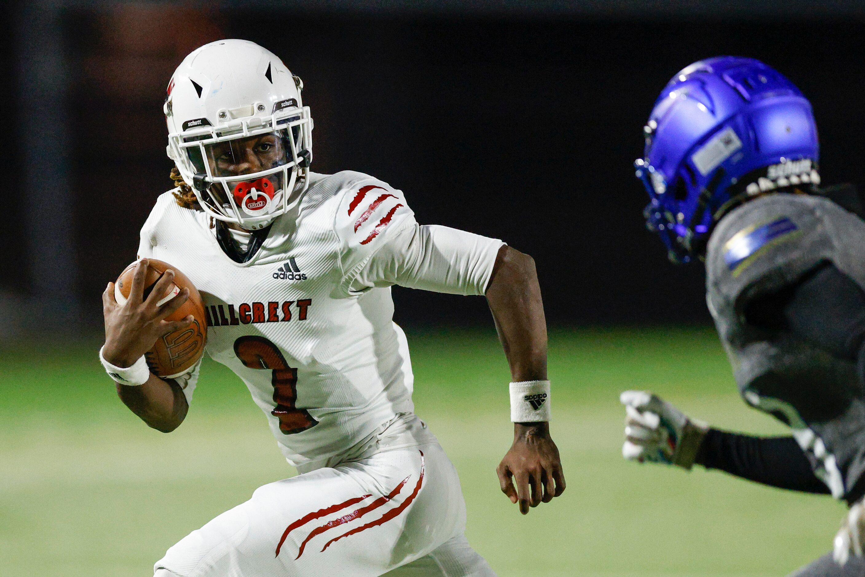 Hillcrest running back Reggie Williams (2) runs the ball for a first down ahead of Conrad...