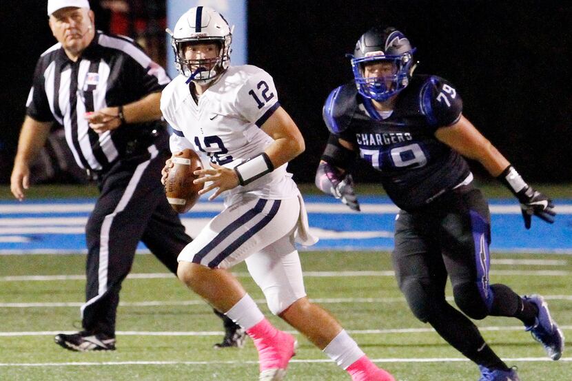 Fort Worth All Saints quarterback Shaun Taylor (12) looks for his receivers while being...