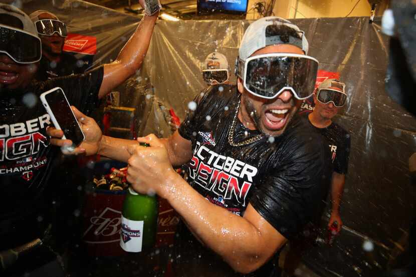 DETROIT, MICHIGAN - SEPTEMBER 25: Nelson Cruz #23 of the Minnesota Twins celebrates winning...