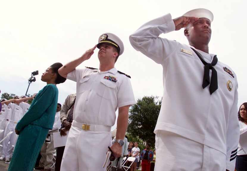 ORG XMIT: S15589771 U.S. Navy NC1 Patrick Grimes, right, salutes with other Navy personell...