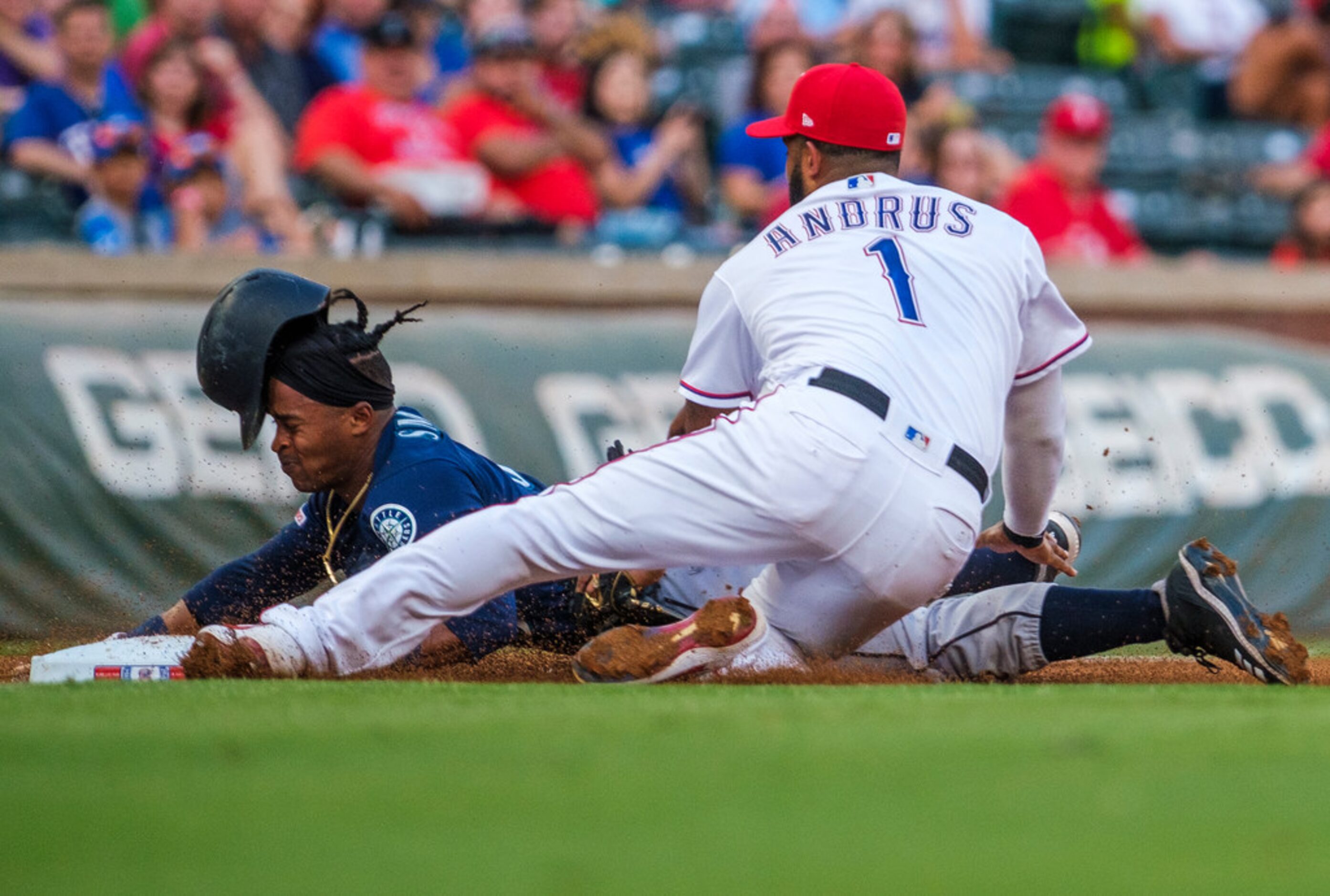 Seattle Mariners right fielder Mallex Smith (0) gets past the tag from Texas Rangers...