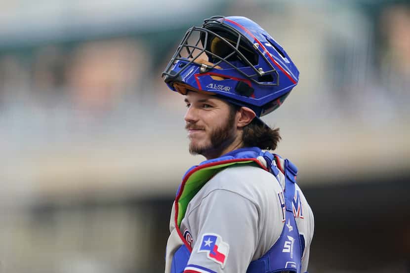 Texas Rangers catcher Jonah Heim looks on during the second inning of a baseball game...