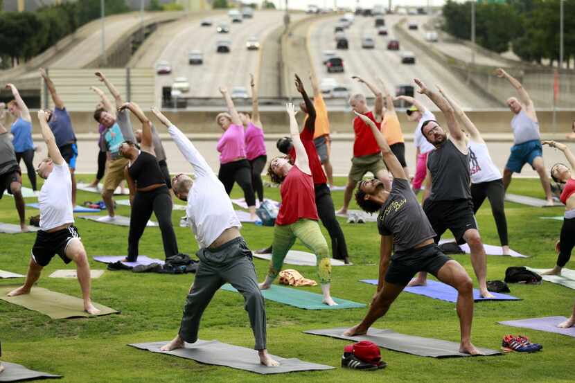 A free yoga class above Woodall Rodgers Freeway on the east side of Klyde Warren Park on...