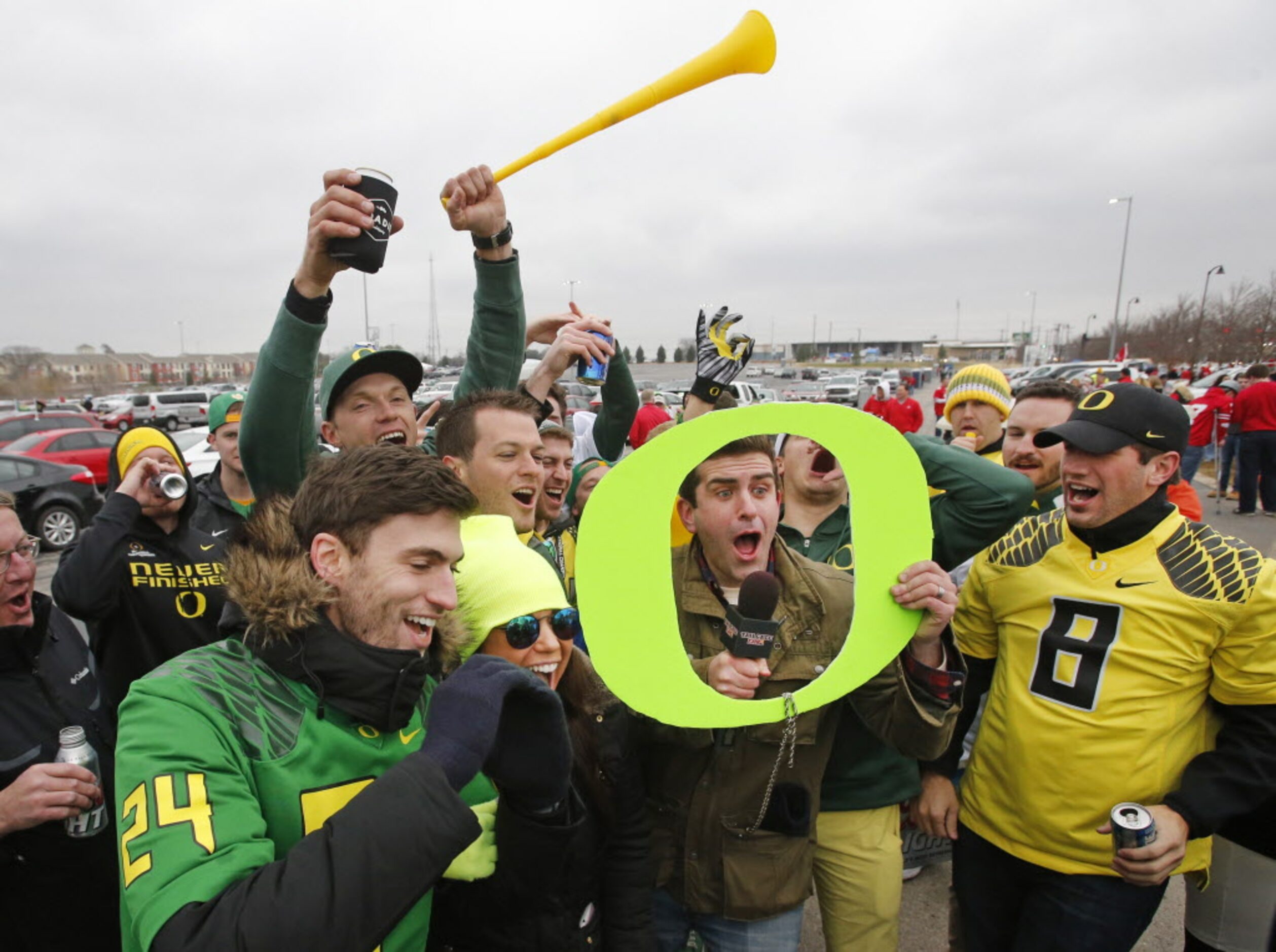 A group of Oregon fans gets excited about a TV crew filming as they tailgate before the...