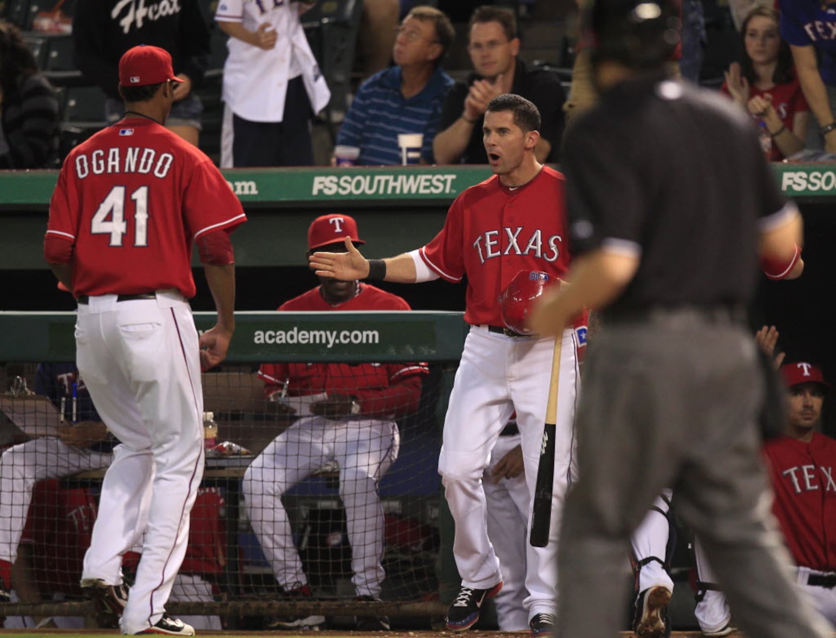 Texas Rangers Mike Napoli removes his gloves after striking out in