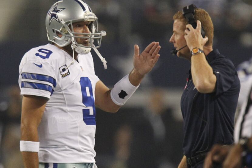Dallas Cowboys quarterback Tony Romo (9) talks to Dallas Cowboys head coach Jason Garrett...