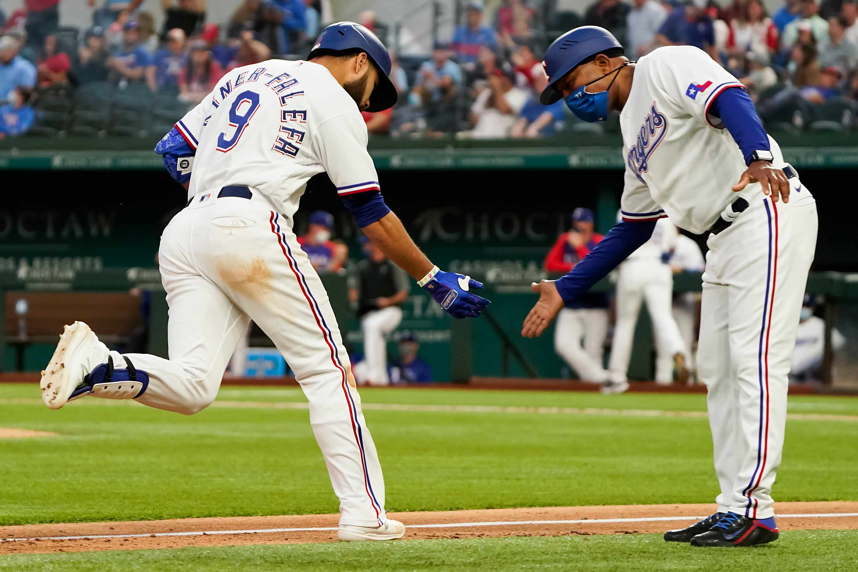 Texas Rangers shortstop Isiah Kiner-Falefa celebrates with third base coach Tony Beasley...