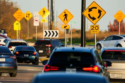 Signs direct traffic into a roundabout at Warren Parkway and Ohio Drive in Frisco on Friday,...