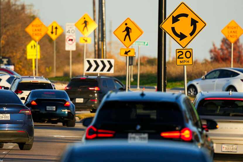 Signs direct traffic into a roundabout at Warren Parkway and Ohio Drive in Frisco, one of...
