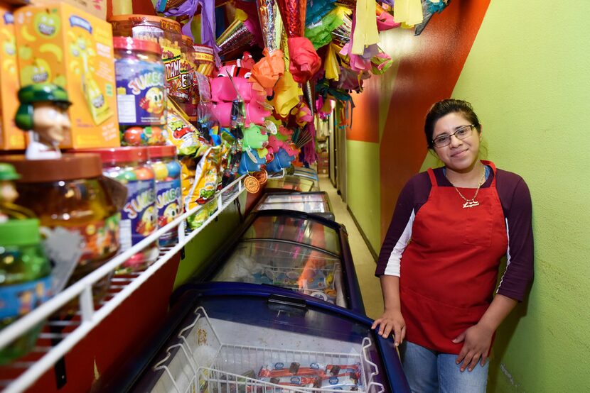 Marymar Nuñez, 19,stands near the many freezers used for icy treats at La China Poblana, a...