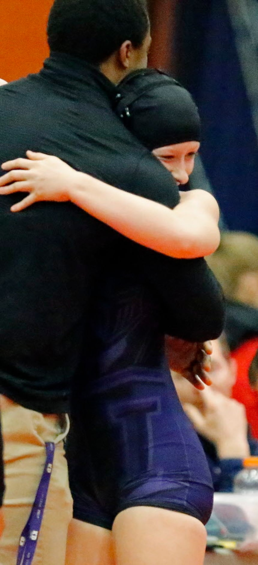 Tabitha Wood of Frisco Independence High School embraces her coach after winning the 119 lb....