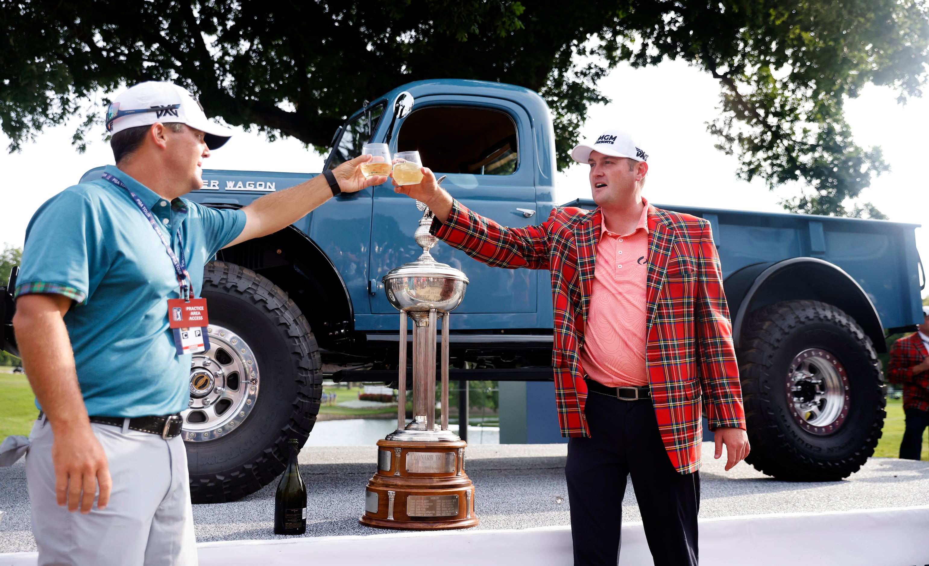 Professional golfer Jason Kokrak shares a champagne toast with caddie David Robinson after...