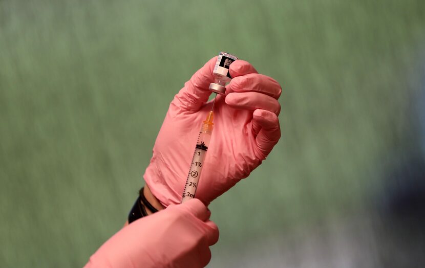 Nurse Miriam Castro prepares a vaccine at Passport Health in Plano. Vaccinations are...