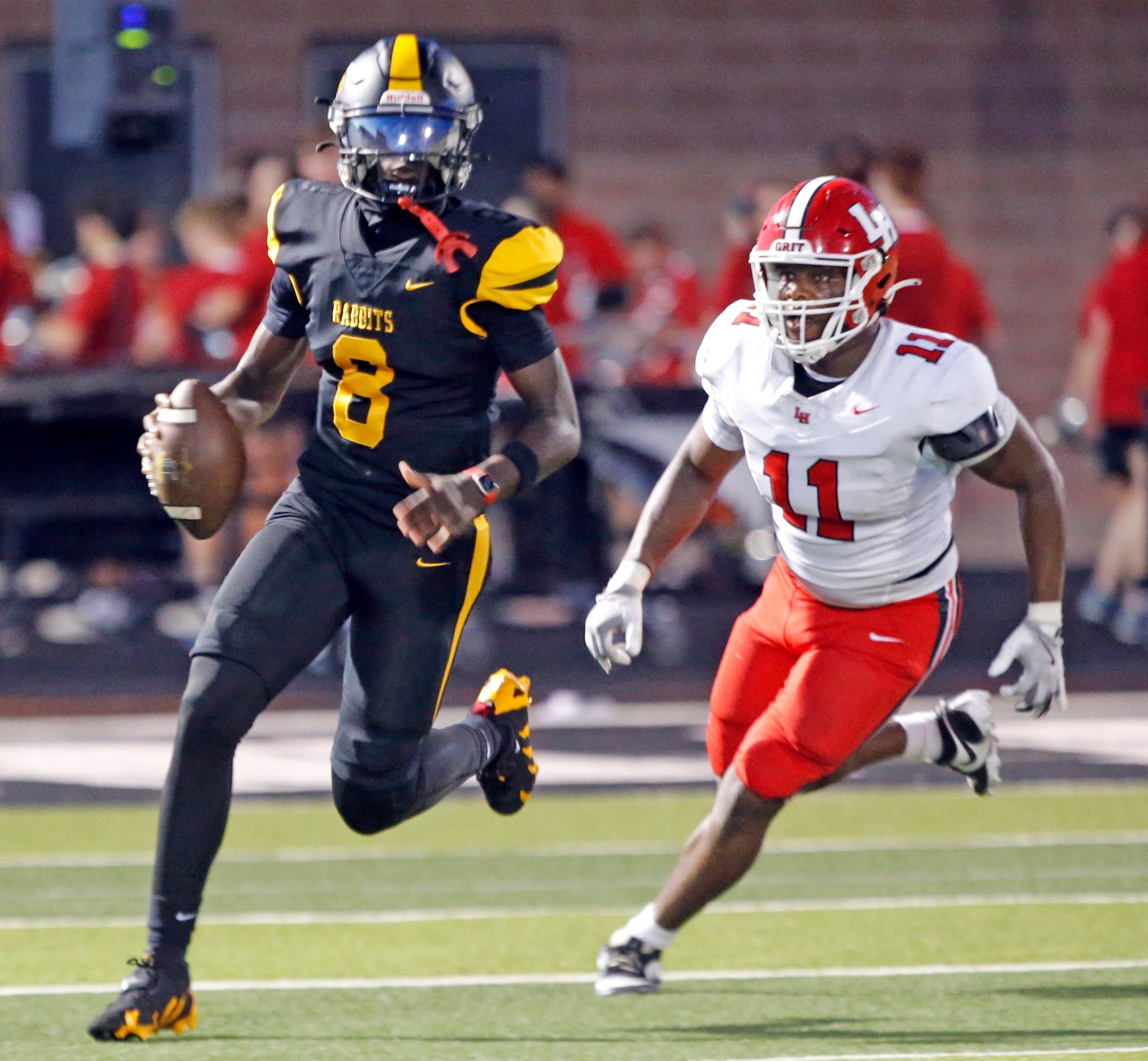 Forney high QB Nelson Peterson, Jr. (8) scrambles from Lake Highlands high defender Michael...