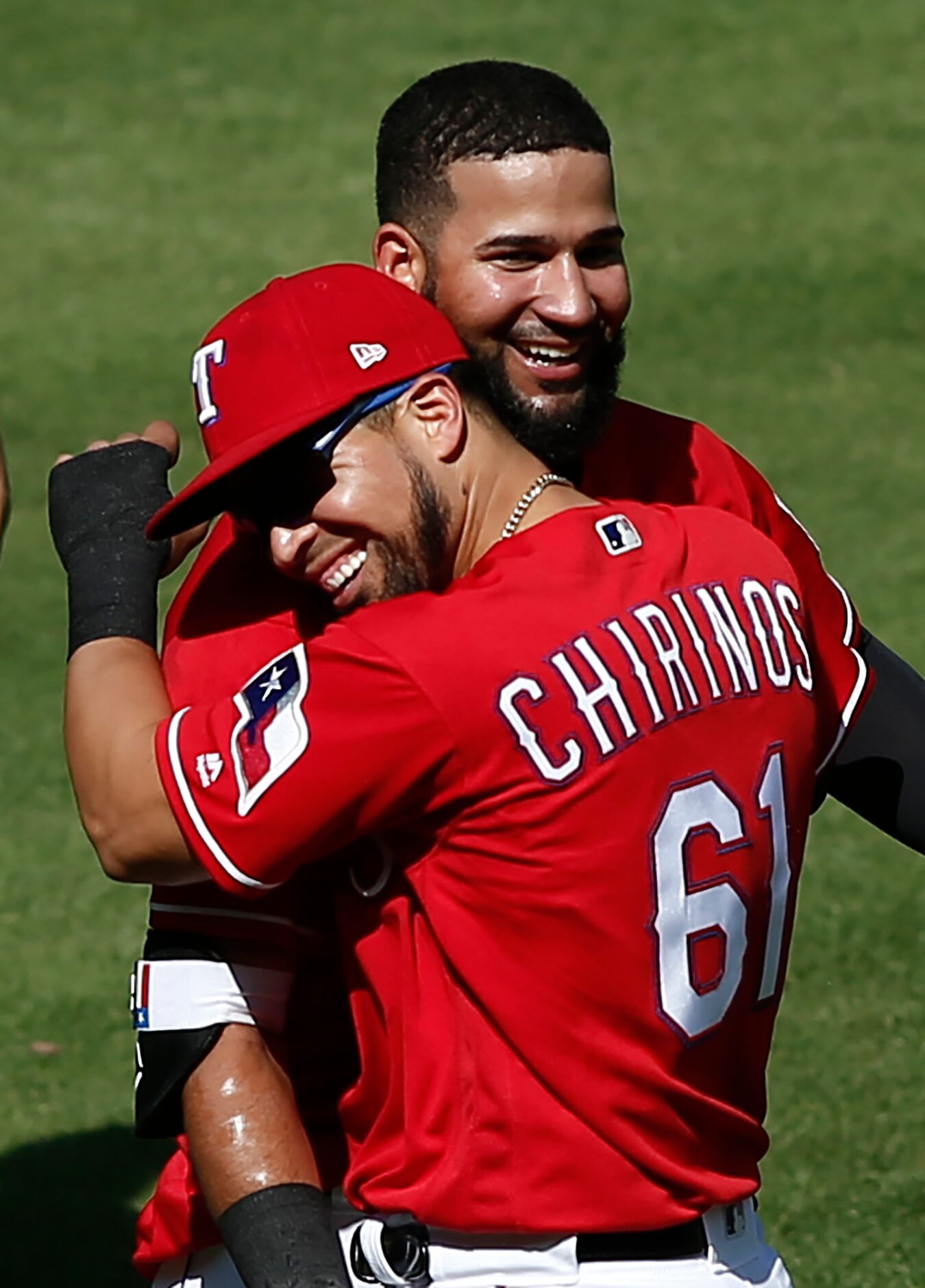 Texas Rangers' Nomar Mazara, top, celebrates with Robinson Chorines (61) after hitting a...