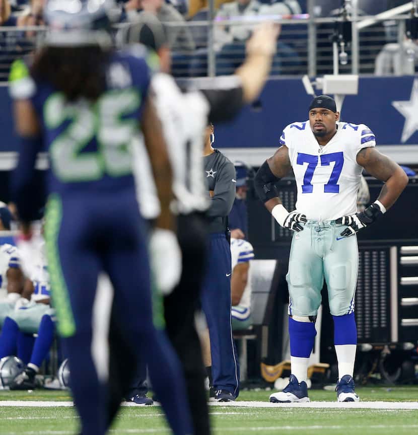 Dallas Cowboys offensive tackle Tyron Smith (77) watches from the sideline as the team plays...