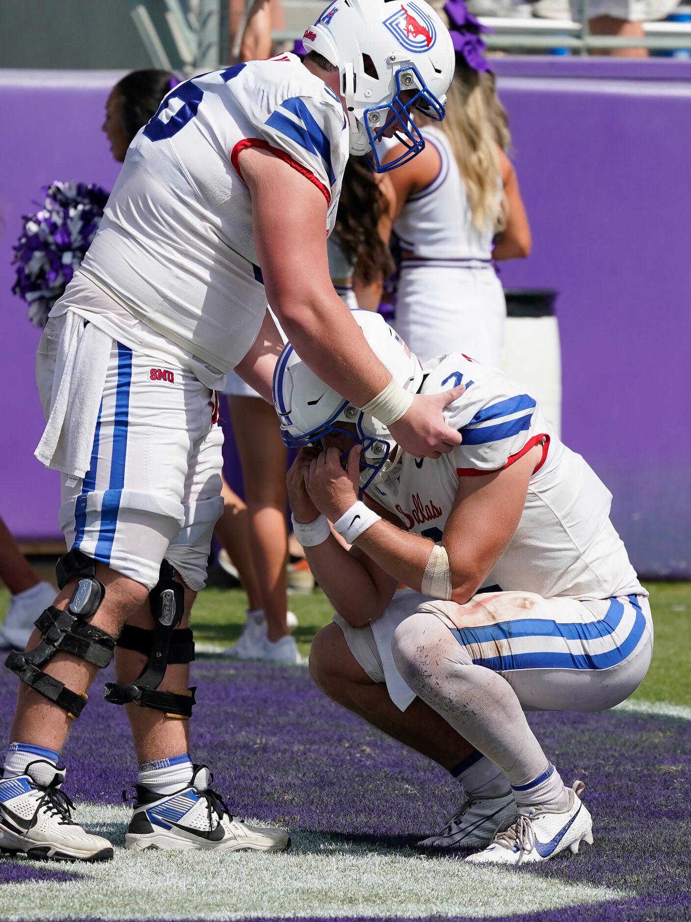 SMU quarterback Preston Stone (2) is comforted by teammate lineman Branson Hickman after an...