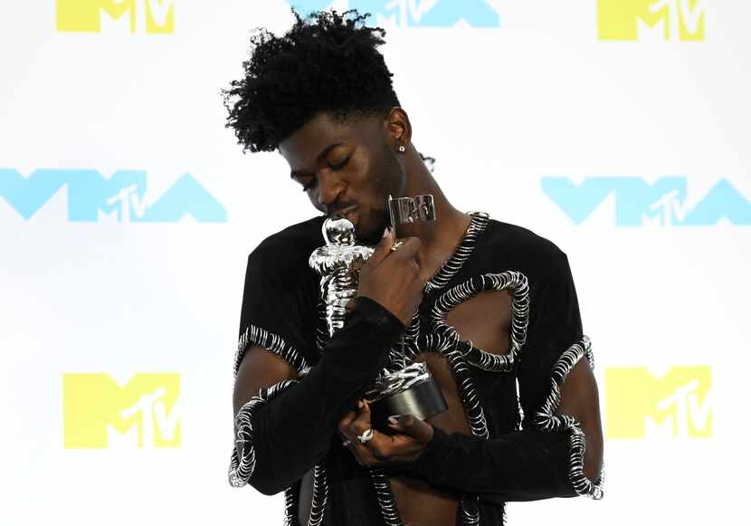 Lil Nas X poses in the press room with the award for best collaboration for "Industry...