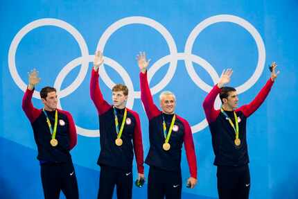 Gold medalists Conor Dwyer, Townley Haas, Ryan Lochte and Michael Phelps wave to the crowd...