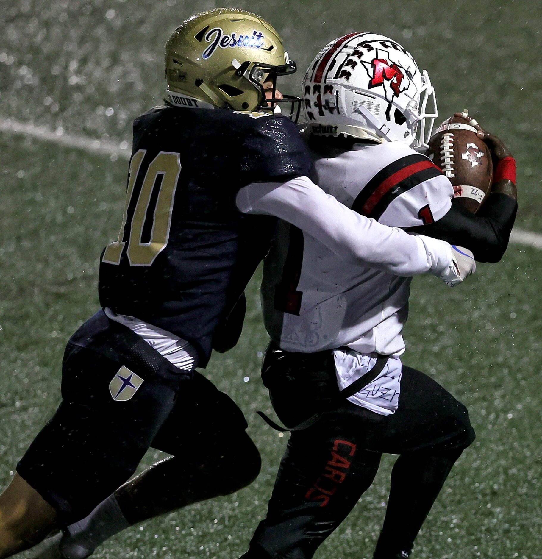 MacArthur running back Darelle Smith (1) is finally stopped by Jesuit Roark Holman (10)...