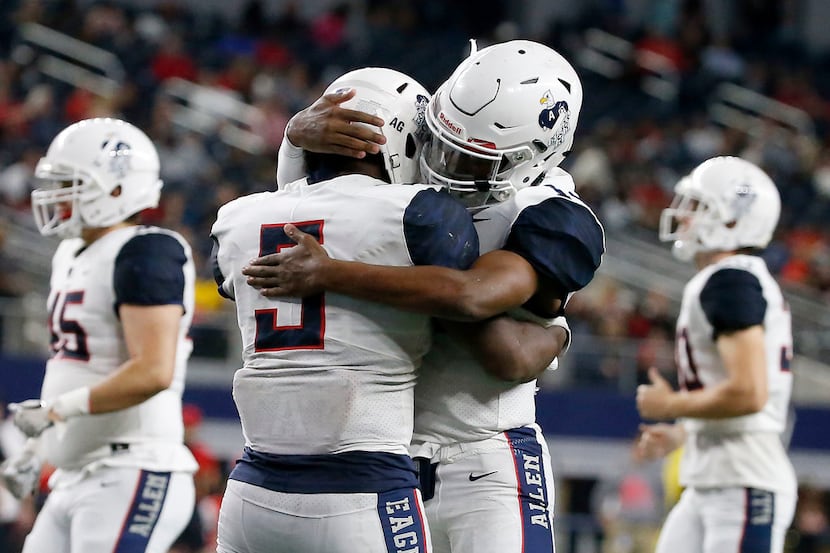 Allen running back Brock Sturges (5) is congratulated by quarterback Grant Tisdale (14)...