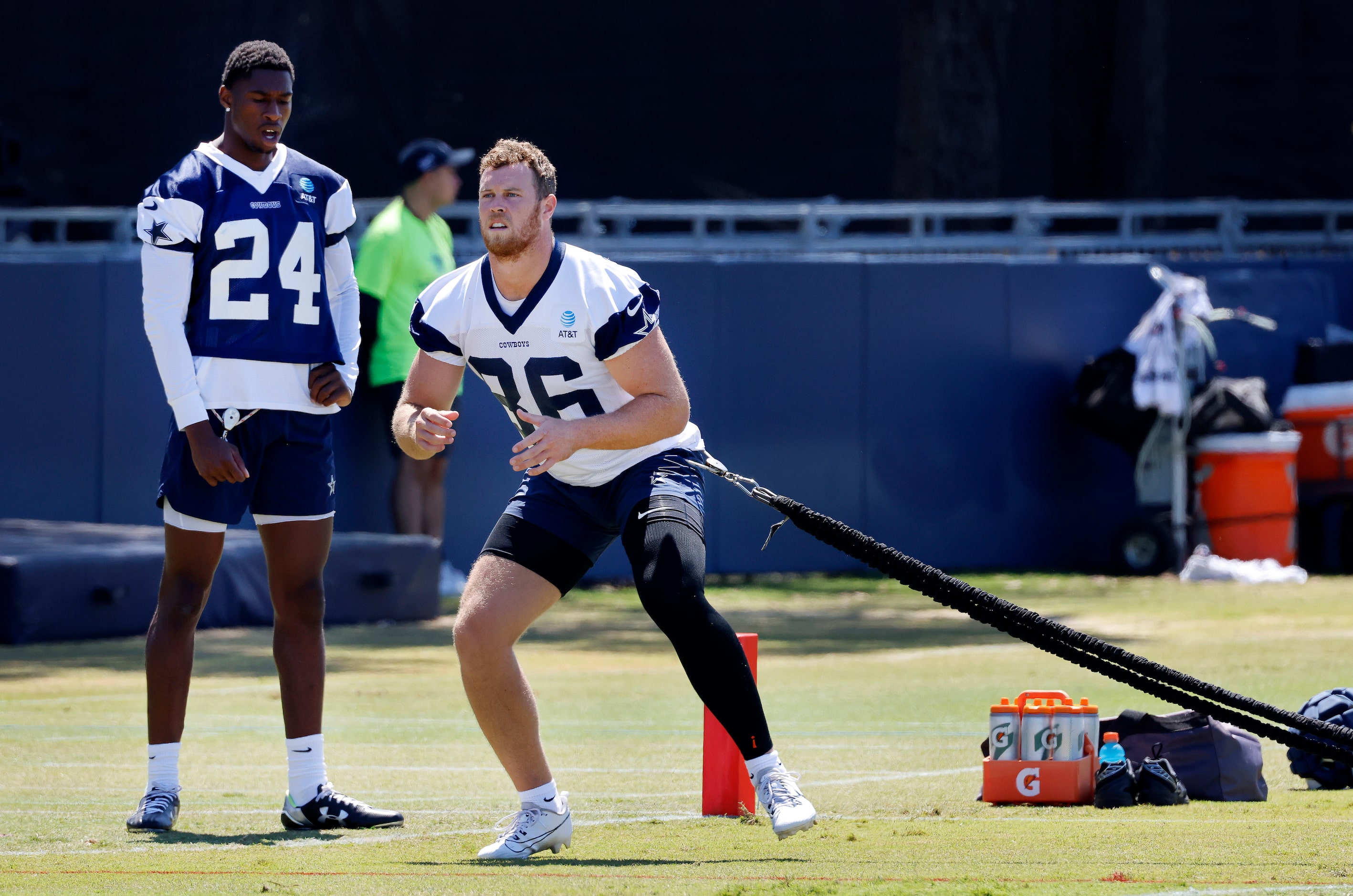 Injured Dallas Cowboys safety Israel Mukuamu (24) and tight end Luke Schoonmaker (86) take...