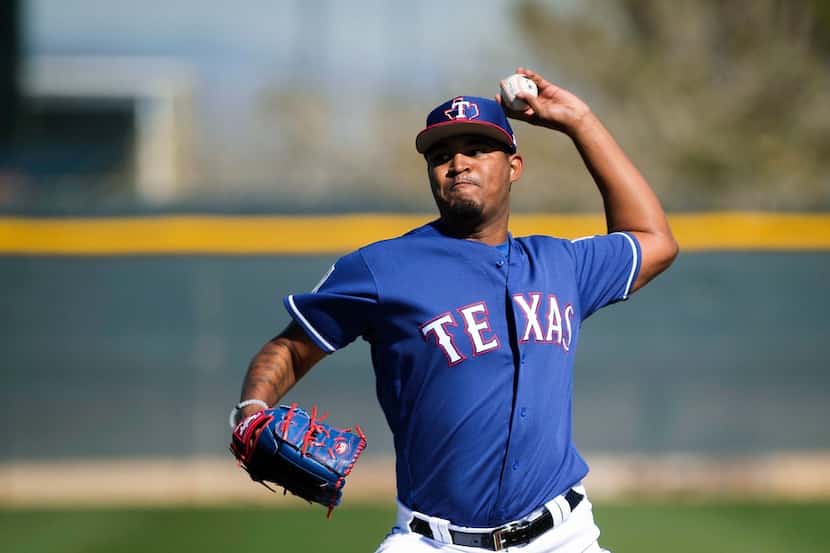 Texas Rangers pitcher Yohander Mendez throws live batting practice during a spring training...