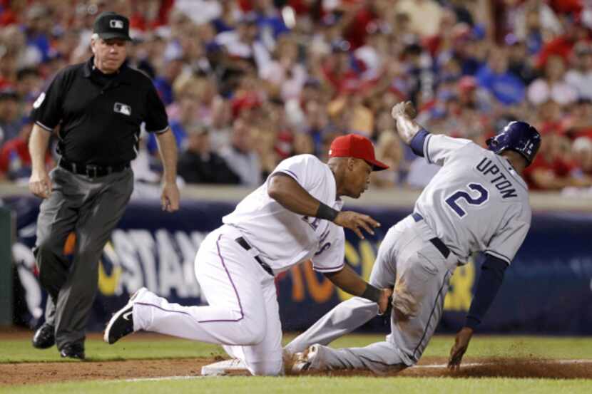 Rangers third baseman Adrian Beltre tags out Tampa Bay’s B.J. Upton, who was trying to steal...