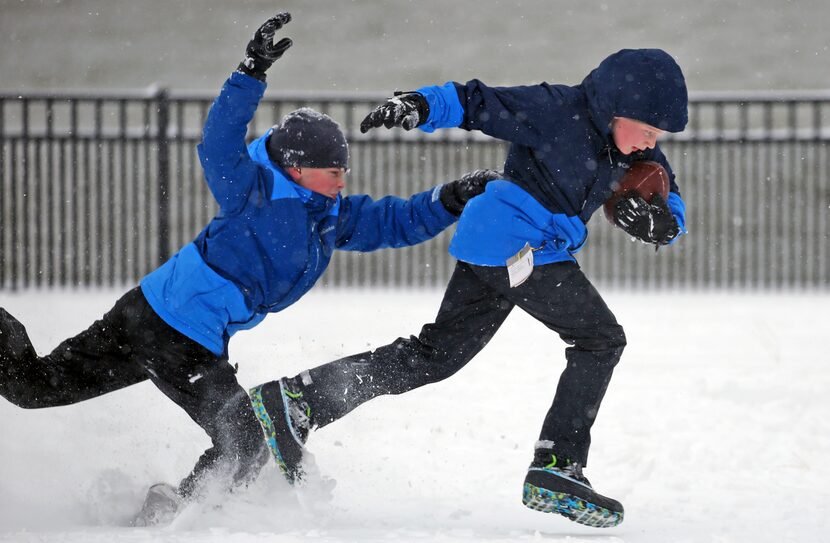 NEWPORT NEWS, VA: Nathan Cochran, 10, attempts to grab Jackson Robbins, 10, as they play...