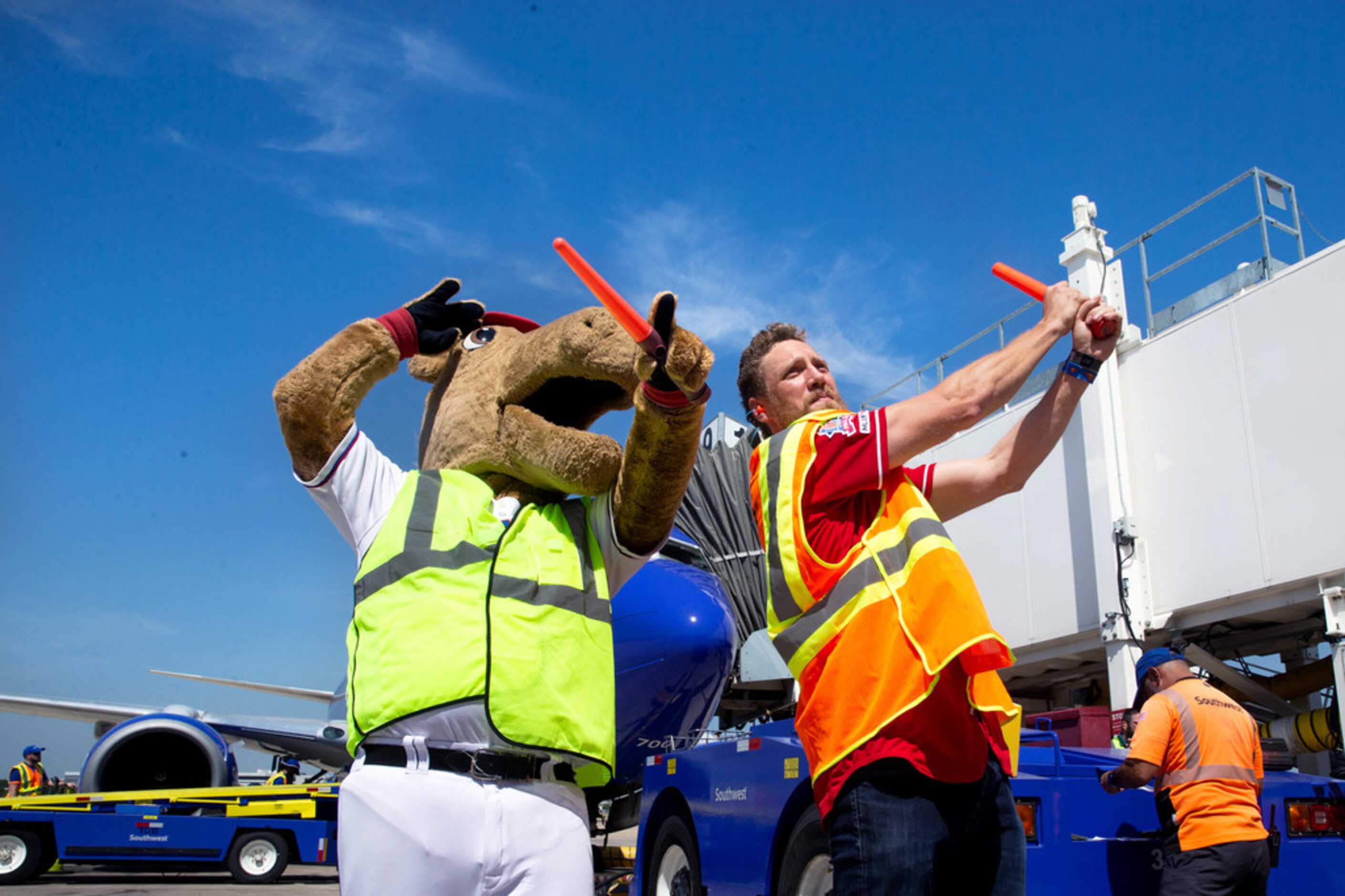 Texas Rangers right fielder Hunter Pence (right) pretends to bat a ball using signal wands...