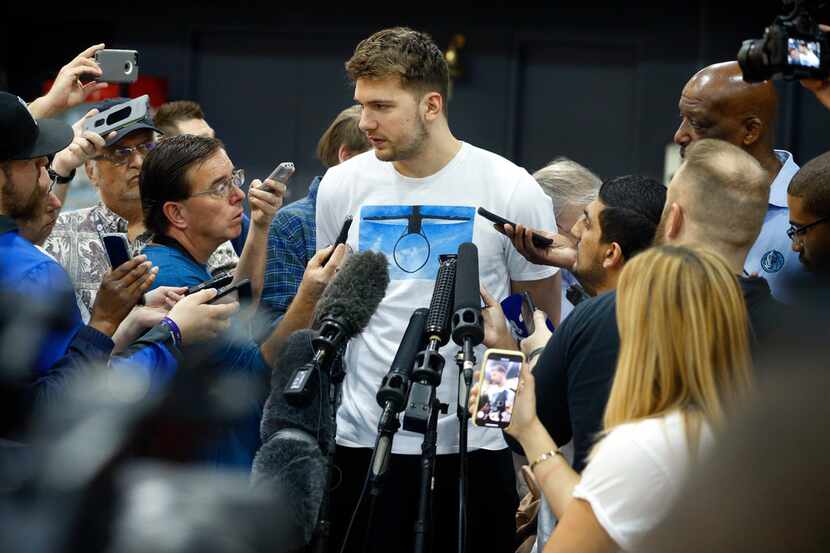FILE - Dallas Mavericks rookie forward Luka Doncic visits with the media a day after the...