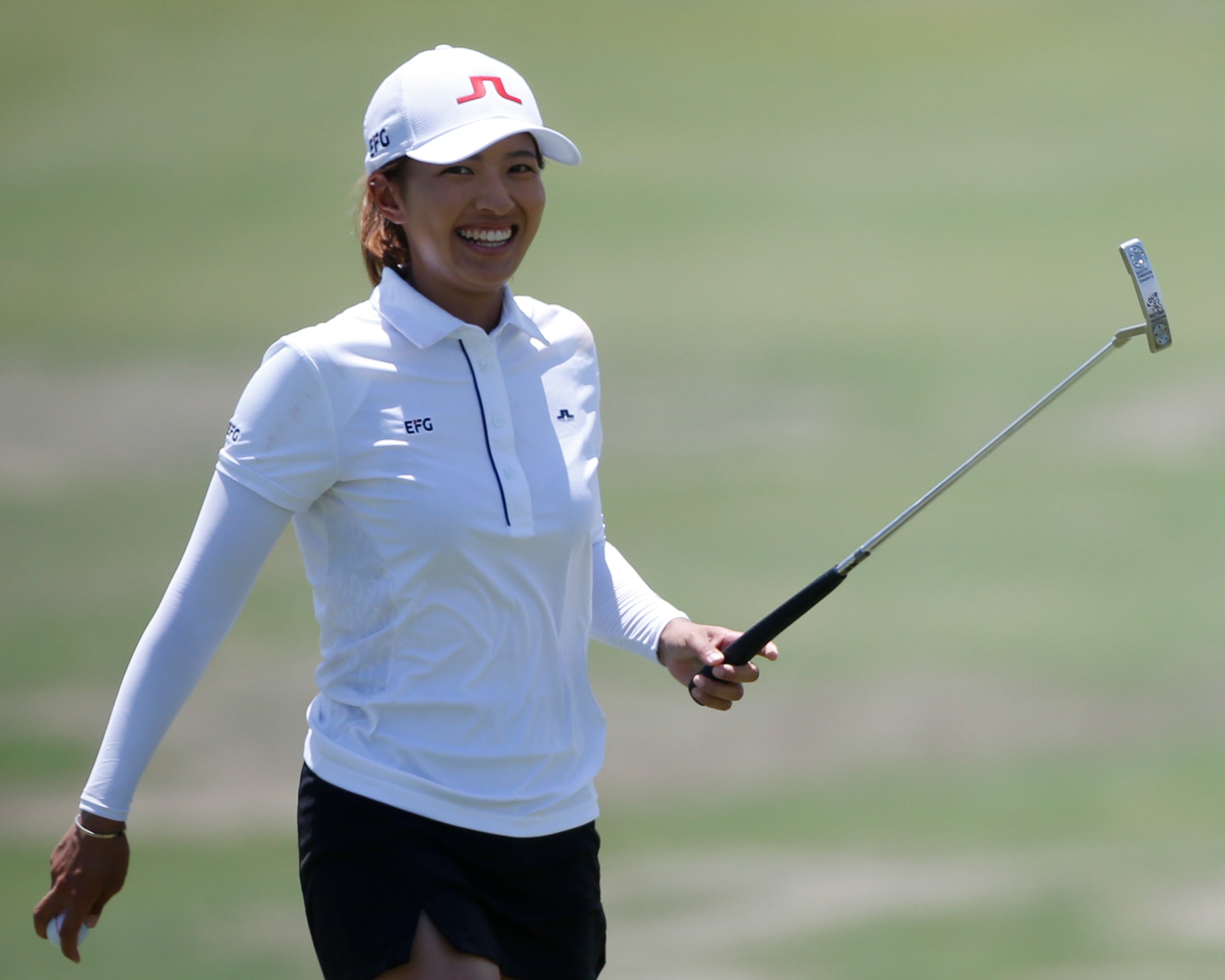 Professional golfer Tiffany Chan smiles after making birdie on the 17th hole during round...