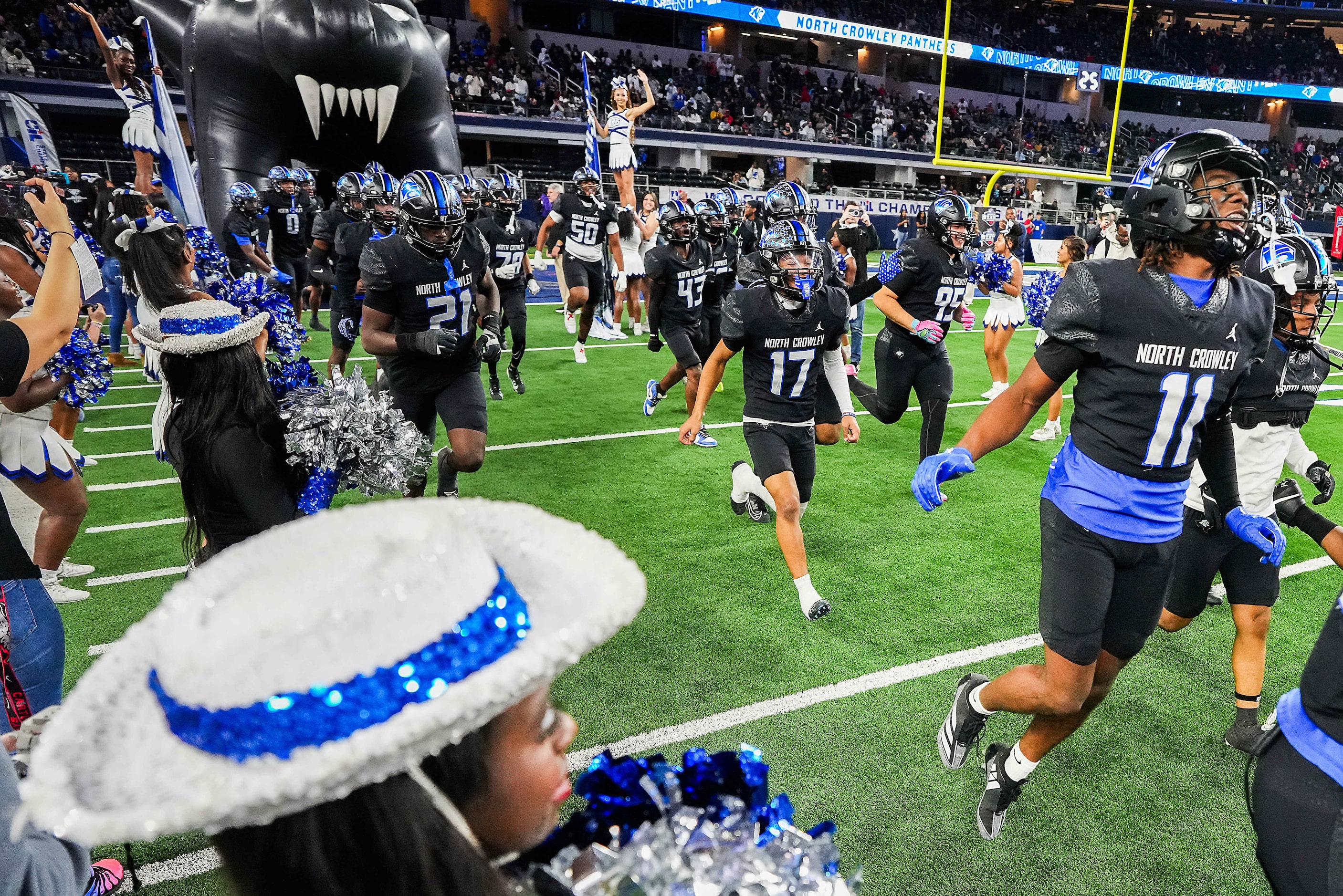 North Crowley wide receiver Cameron Hunter (11) takes the field with teammates before the...