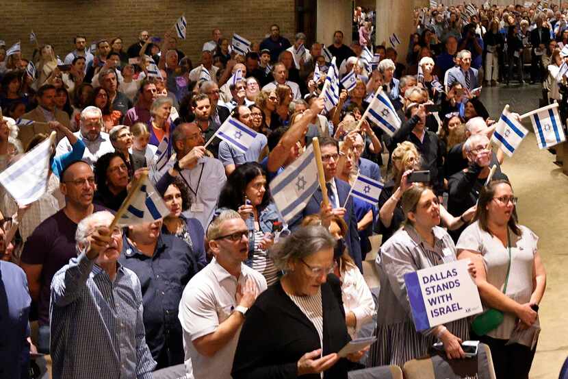 Supporters of Israel hold Israel flags during a community solidarity gathering for Israel at...