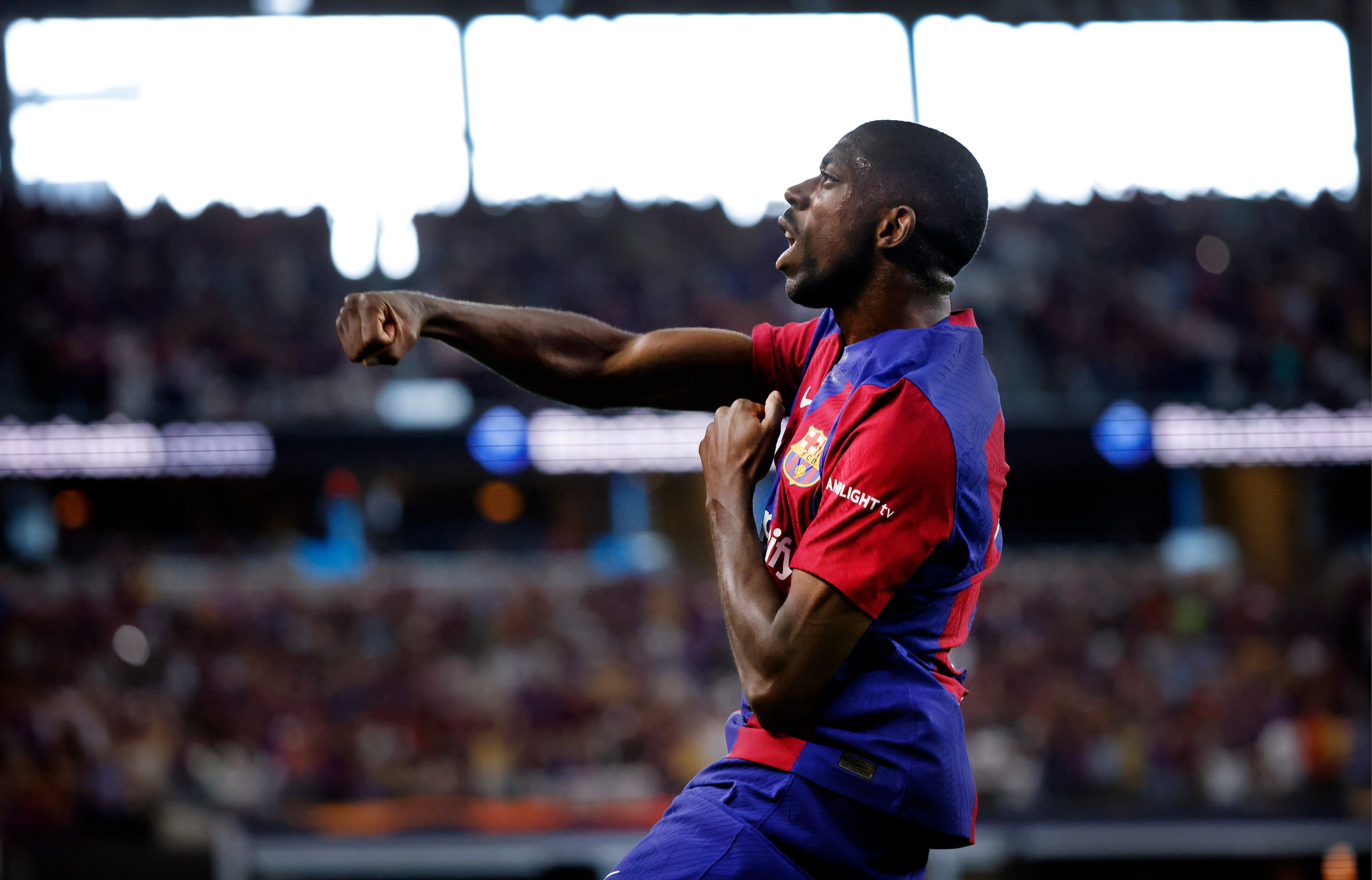 Barcelona forward Ousmane Dembélé (7) celebrates his first half score on Real Madrid...