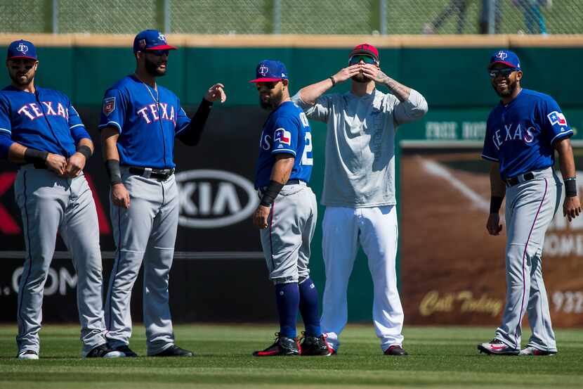 Cleveland Indians first baseman Mike Napoli blows kisses toward the Texas Rangers bench as...