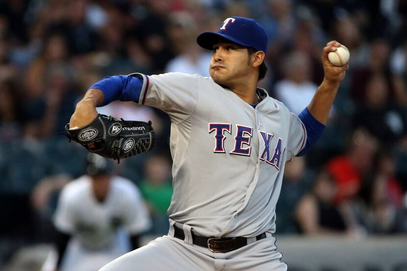 Texas Rangers starting pitcher Martin Perez (33) delivers to the Chicago White Sox in the...