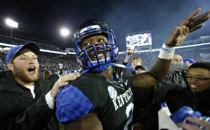 Alvin Dupree #2 of the Kentucky Wildcats celebrates with fans after the game against the...