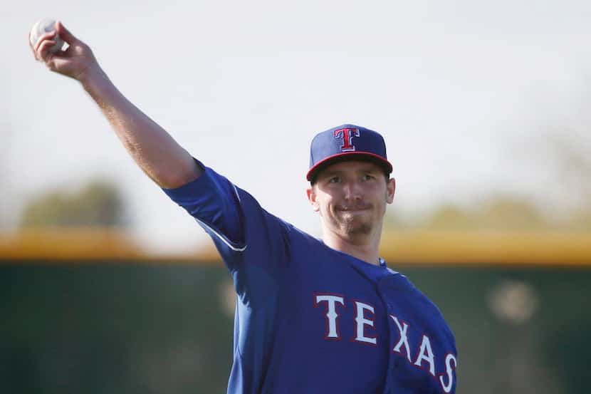 Texas Rangers pitcher Tanner Scheppers (52) throws during a workout at the Rangers spring...