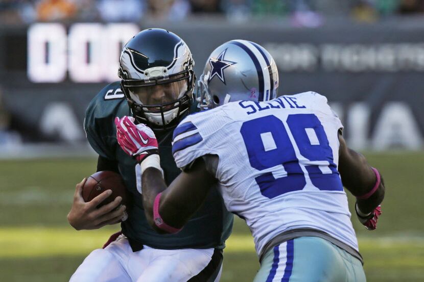 Dallas Cowboys defensive end George Selvie (99) tackles Philadelphia Eagles quarterback Nick...