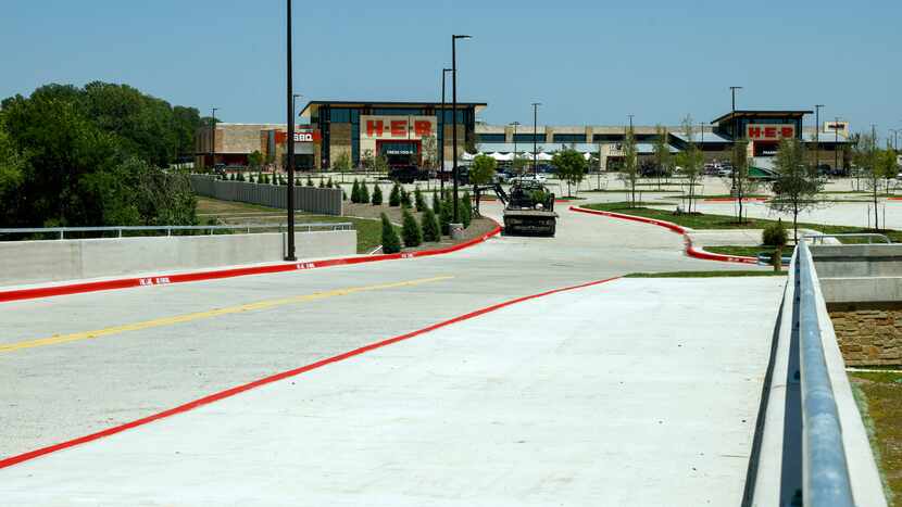 The McKinney H-E-B store is seen from a bridge that connects its parking lot to Custer Road....