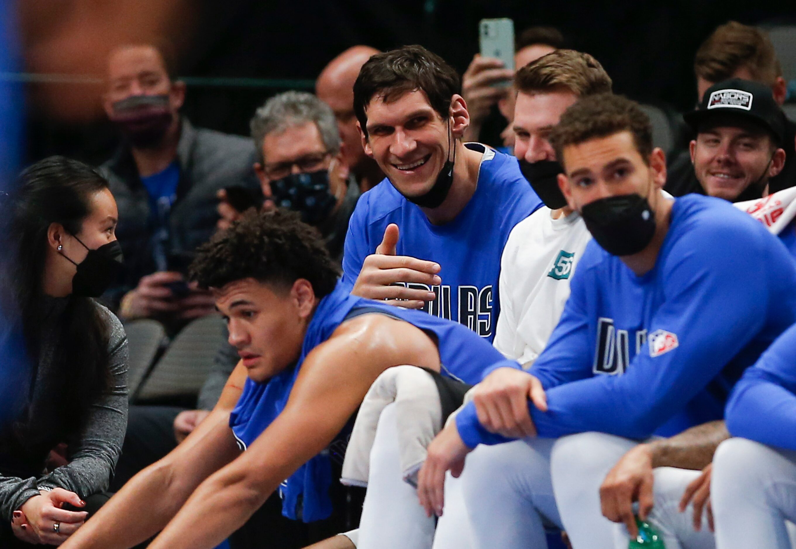 Dallas Mavericks center Boban Marjanovic, center, reacts as fans chant “We want Boban”...