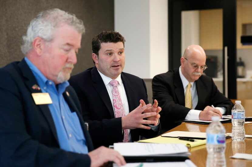 Dallas attorney J.J. Koch, center, answers questions in an editorial board meeting as former...