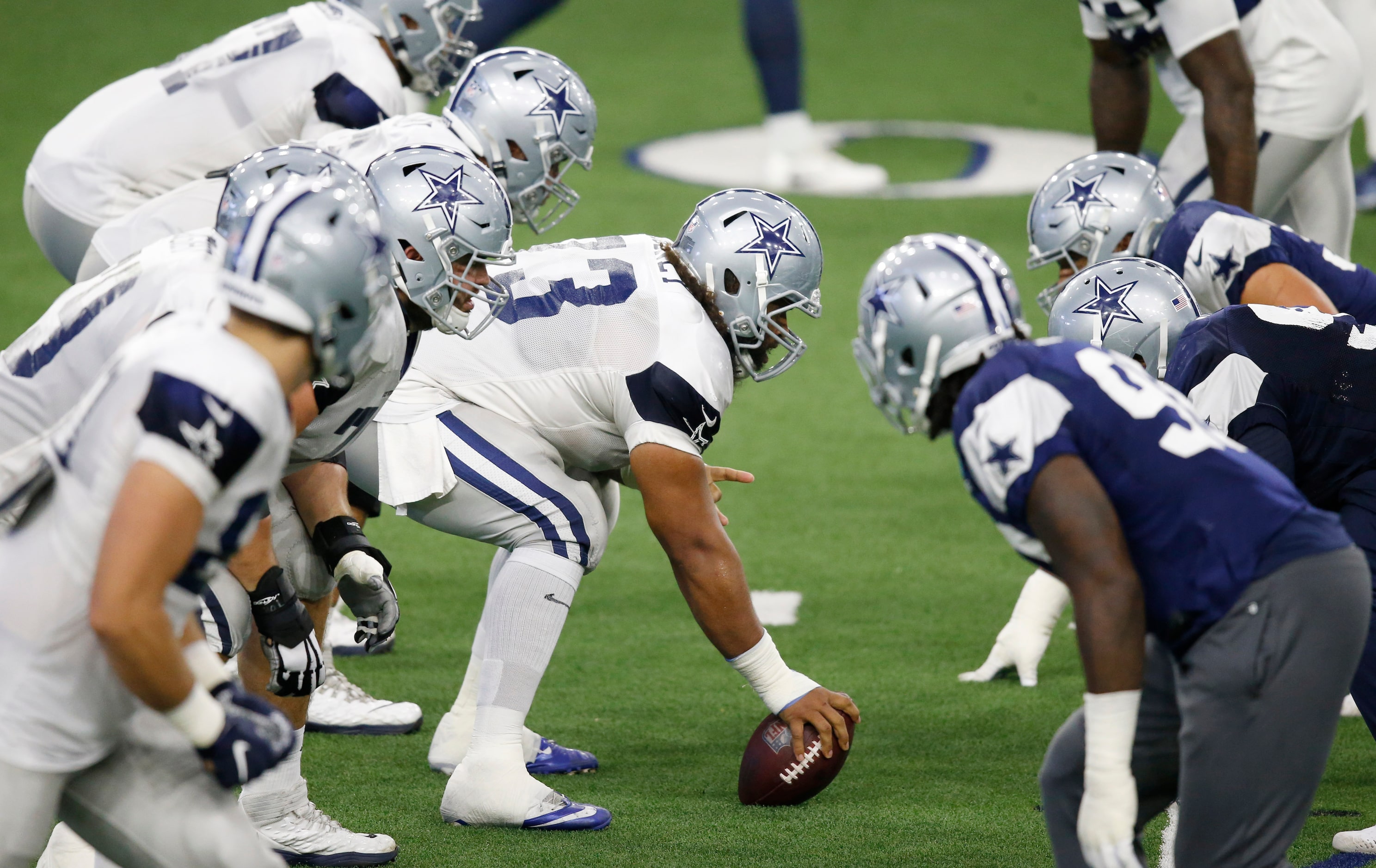 Dallas Cowboys center Joe Looney (73) prepares to snap the ball in practice during training...