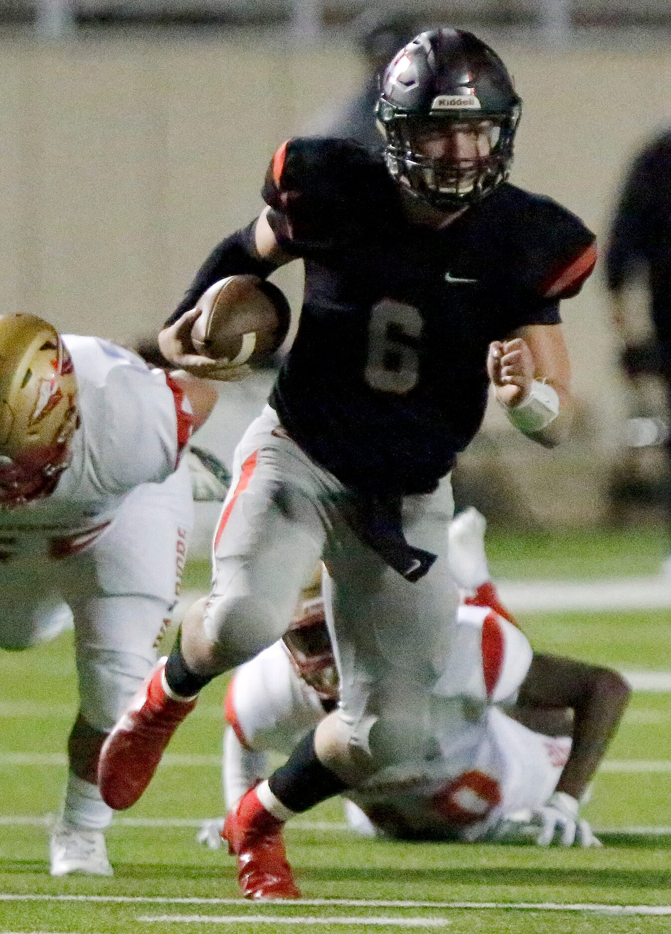 Lake Highlands High School quarterback Mitch Coulson (6) runs the football during the first...